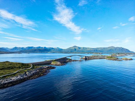 A breathtaking aerial shot of the iconic Atlantic Ocean Road Bridge in Norway against a scenic coastal backdrop.