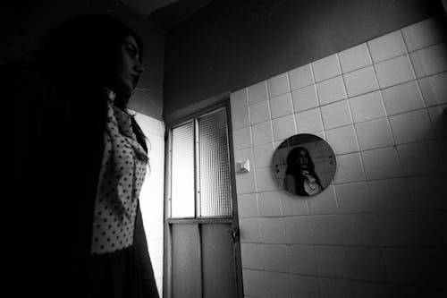 Free A woman is standing in front of a mirror Stock Photo