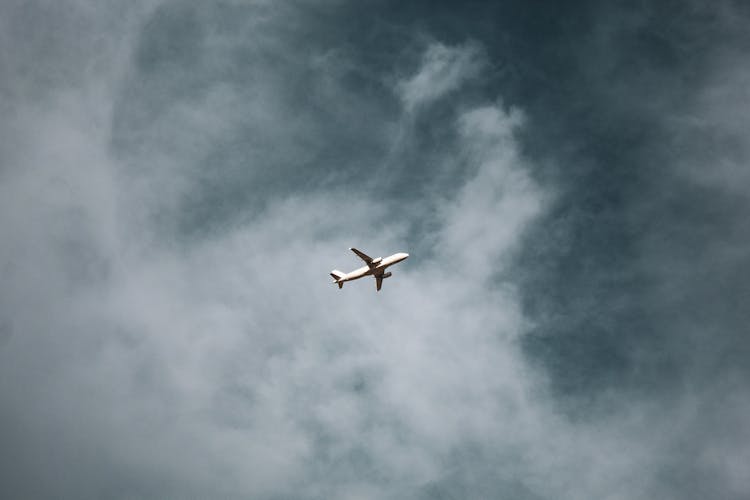 White Plane On Air Under Cloudy Sky