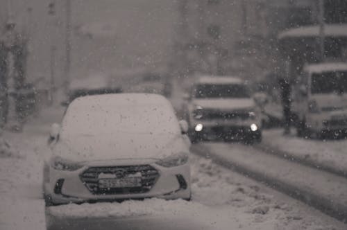 A car is parked on a snowy street