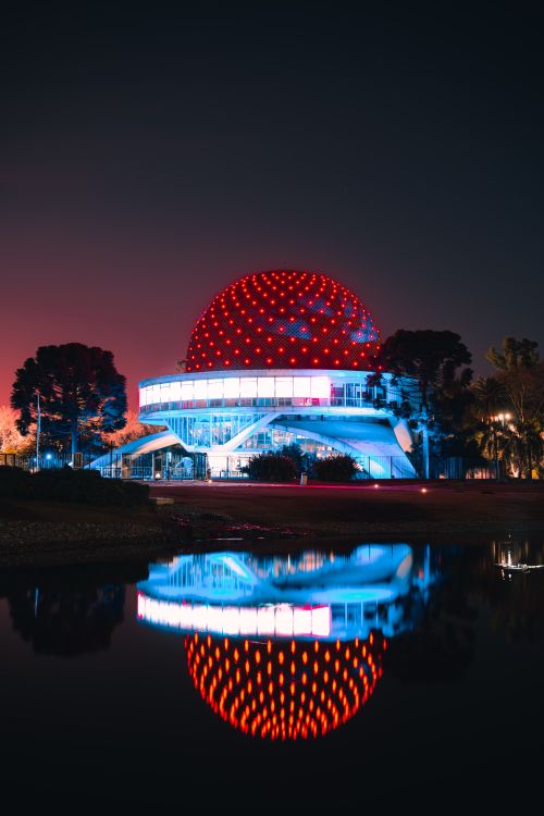 Free Stunning night view of the illuminated Galileo Galilei Planetarium reflecting in water, Buenos Aires. Stock Photo