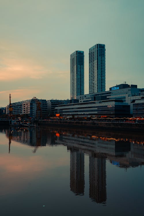 The city skyline is reflected in the water