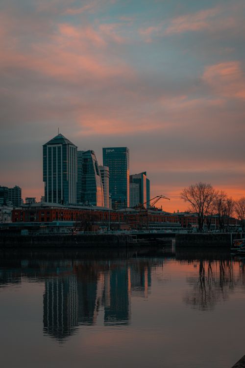 Free Beautiful skyline of Buenos Aires reflecting in the water at sunset, showcasing modern architecture. Stock Photo