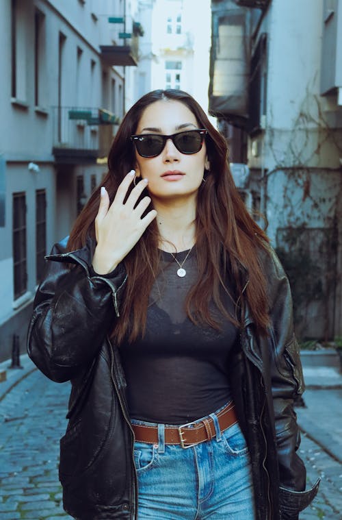 Young, Fashionable Woman Standing on a Street in City 