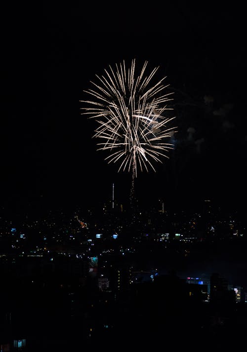 Fireworks over the city at night with a black sky