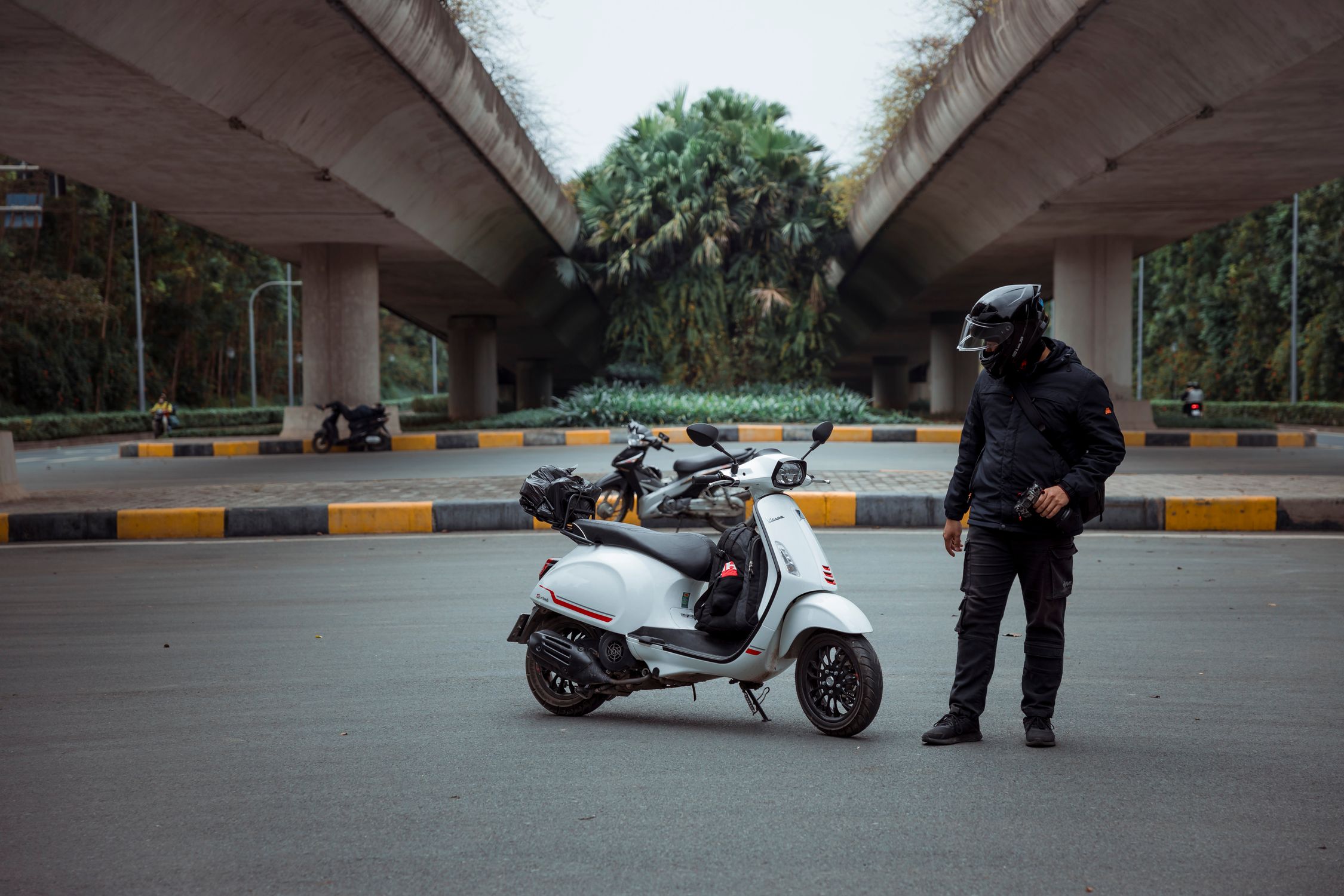 Man in a Safety Helmet Standing next to a Motor Scooter · Free Stock Photo
