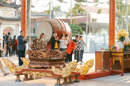 A group of people standing around a large wooden box