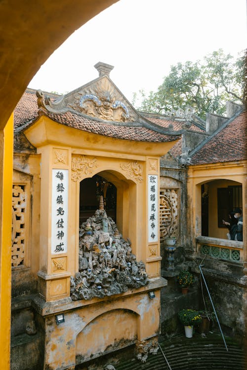 A yellow building with a statue in front of it