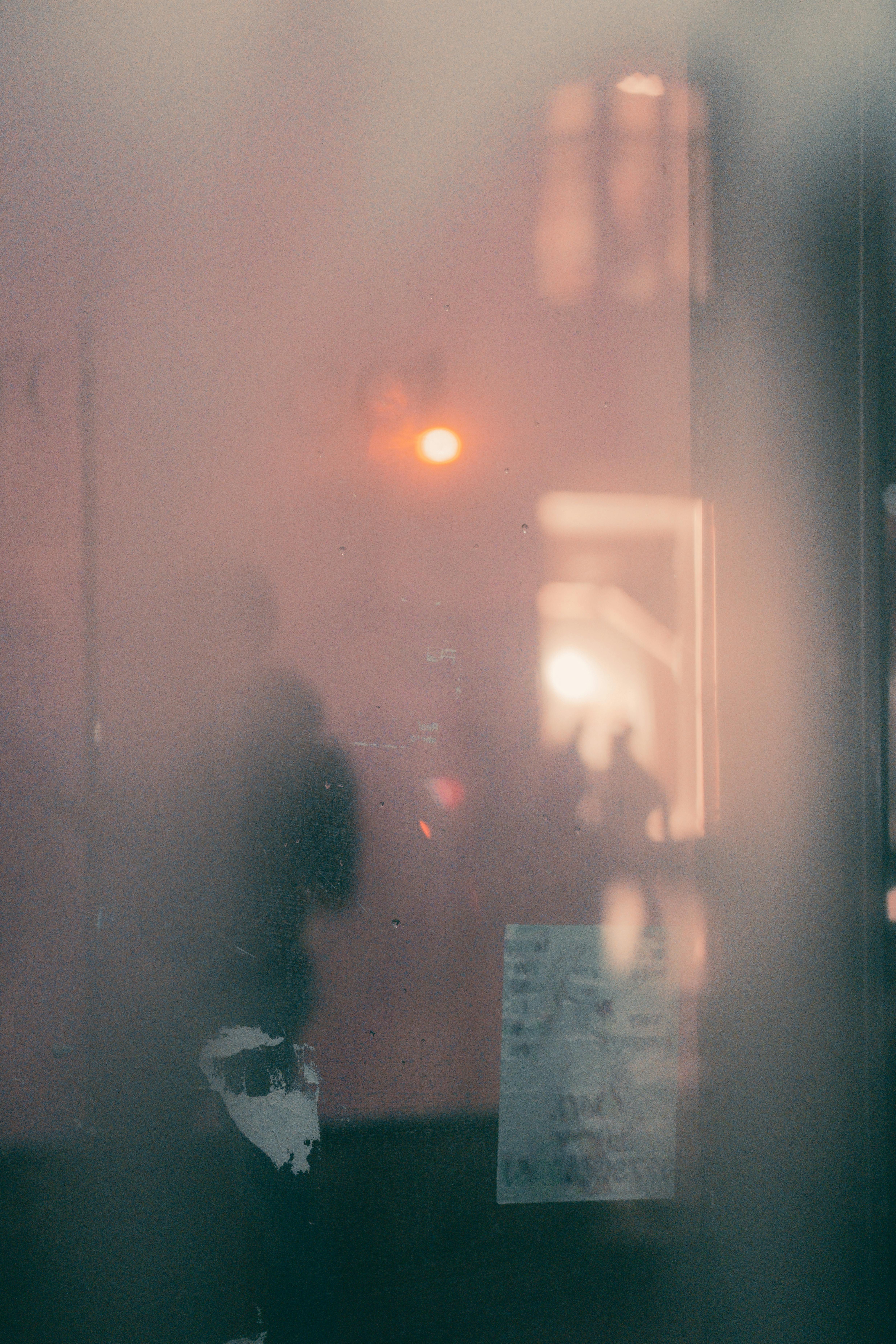 Blurry silhouettes on a foggy London street creating a moody atmosphere.