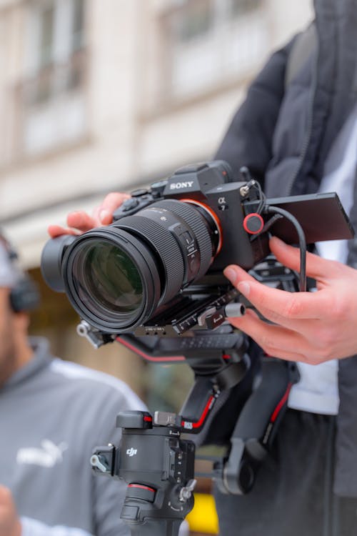 Close-up of a Man Holding a Professional Camera 