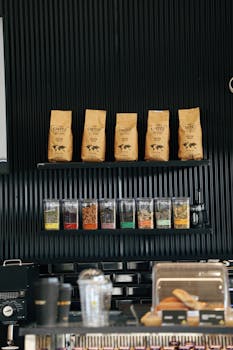 Elegant display of coffee bags and ingredients in a modern café setting.