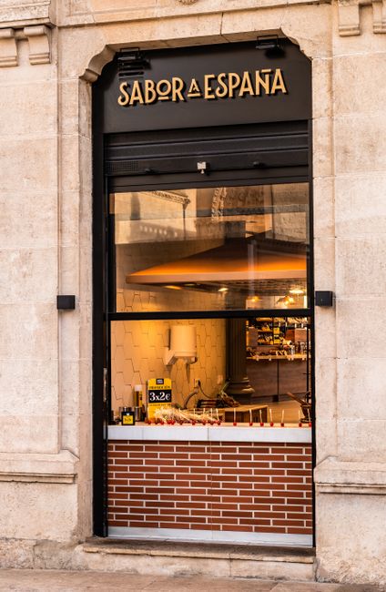Close-up of the Sabor a España storefront in Burgos, Spain showcasing the architectural design.