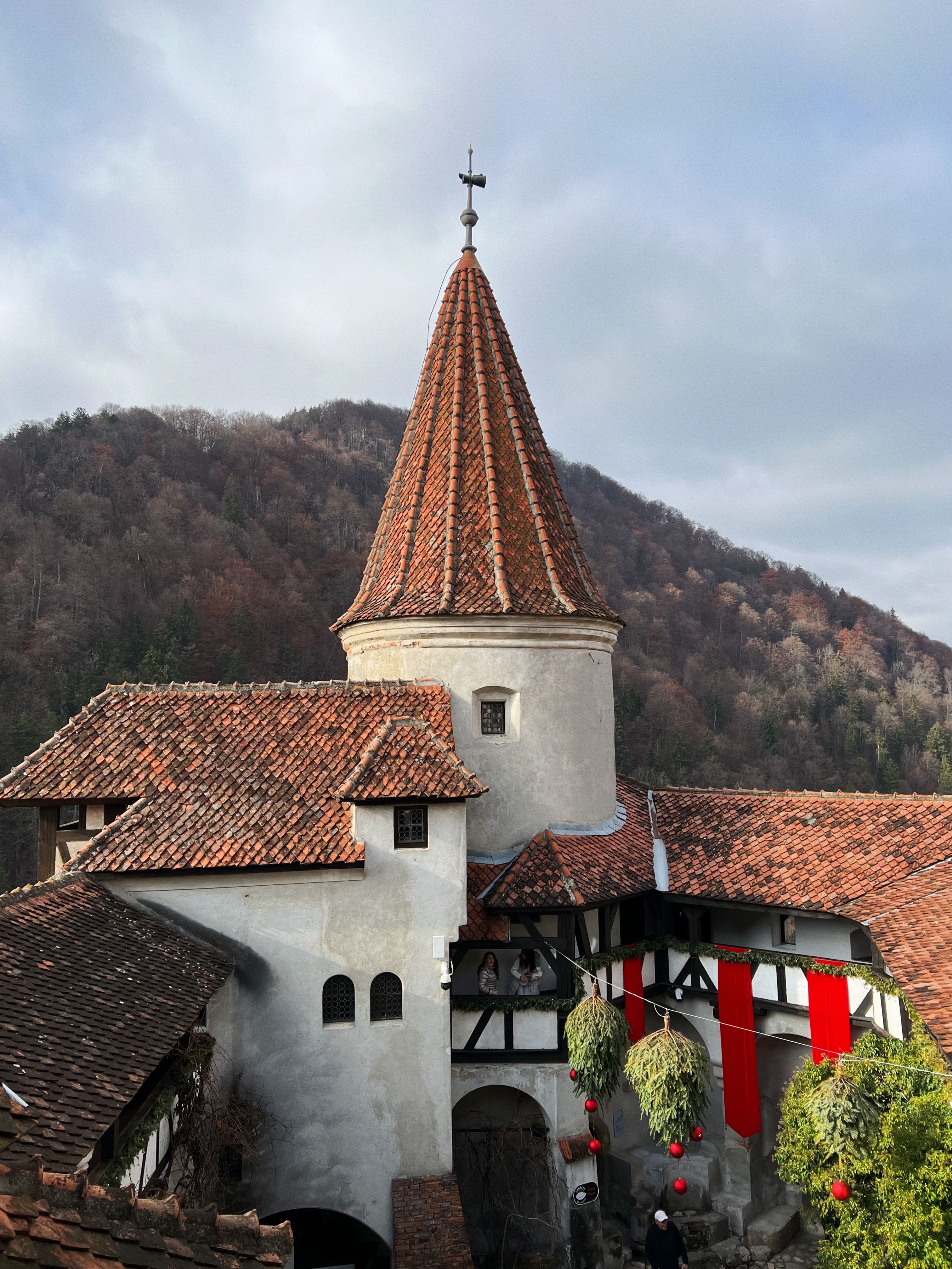 A view of Bran Castle against an autumn backdrop in Romania.