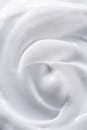 A close up of a white cream on a gray background
