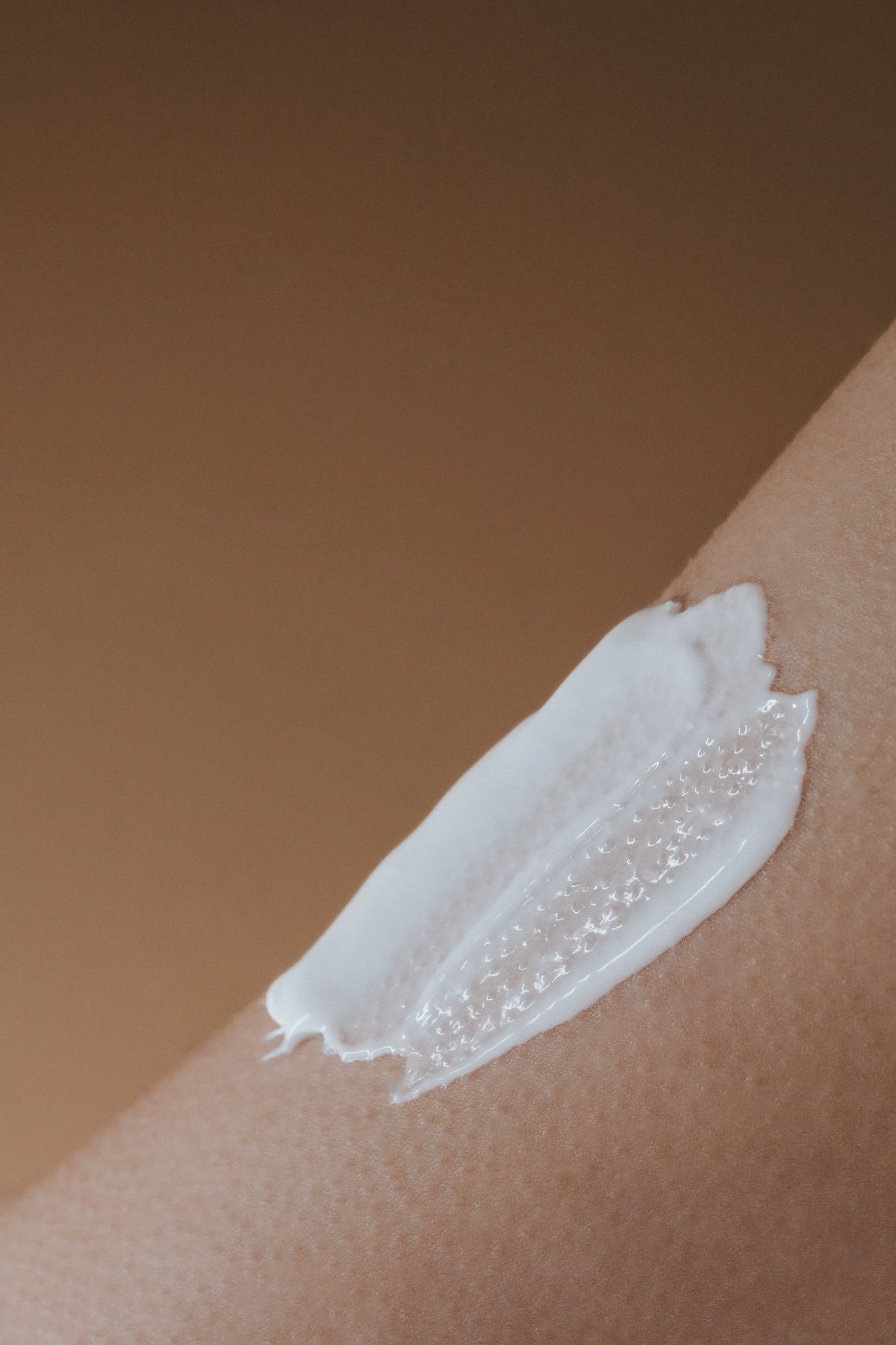 Close-up of moisturizing cream being applied to dry skin