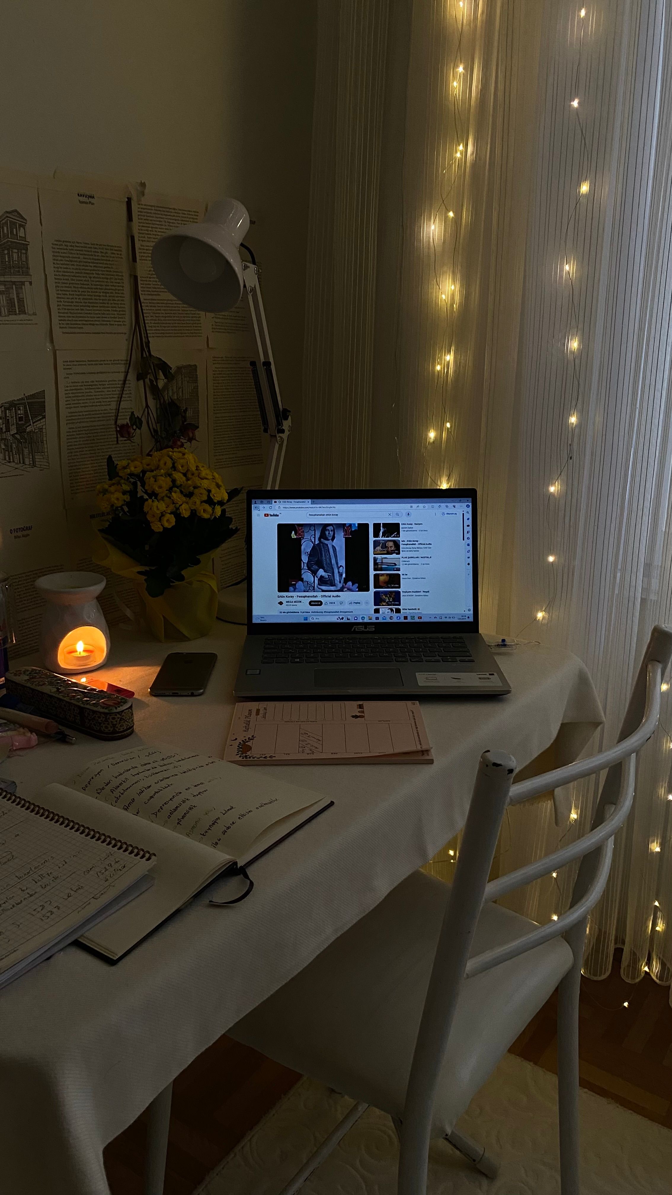 A focused college student organizing notes and planning assignments at a desk
