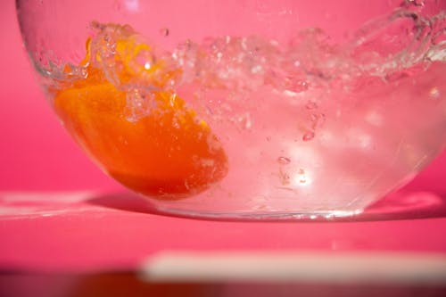 オレンジ, しぶき, ピンクの背景の無料の写真素材