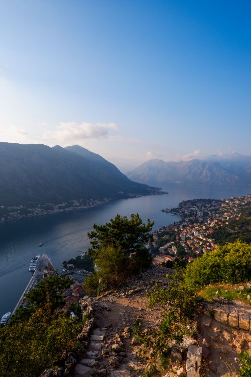 Free Panoramic view of the Bay of Kotor and its surrounding landscape, capturing the tranquil water and distant mountains at sunset. Stock Photo