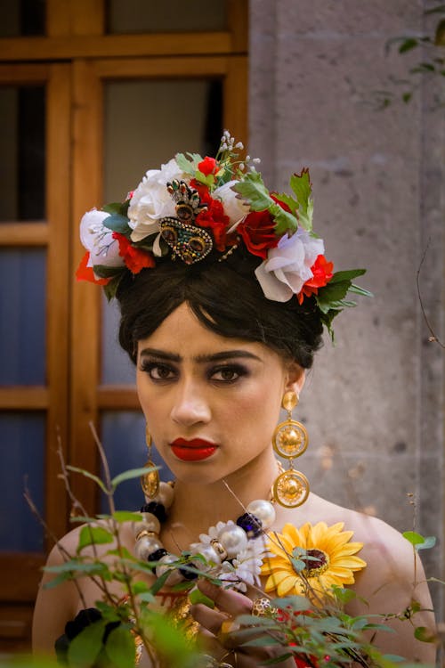 A woman wearing a flower crown and sunflowers