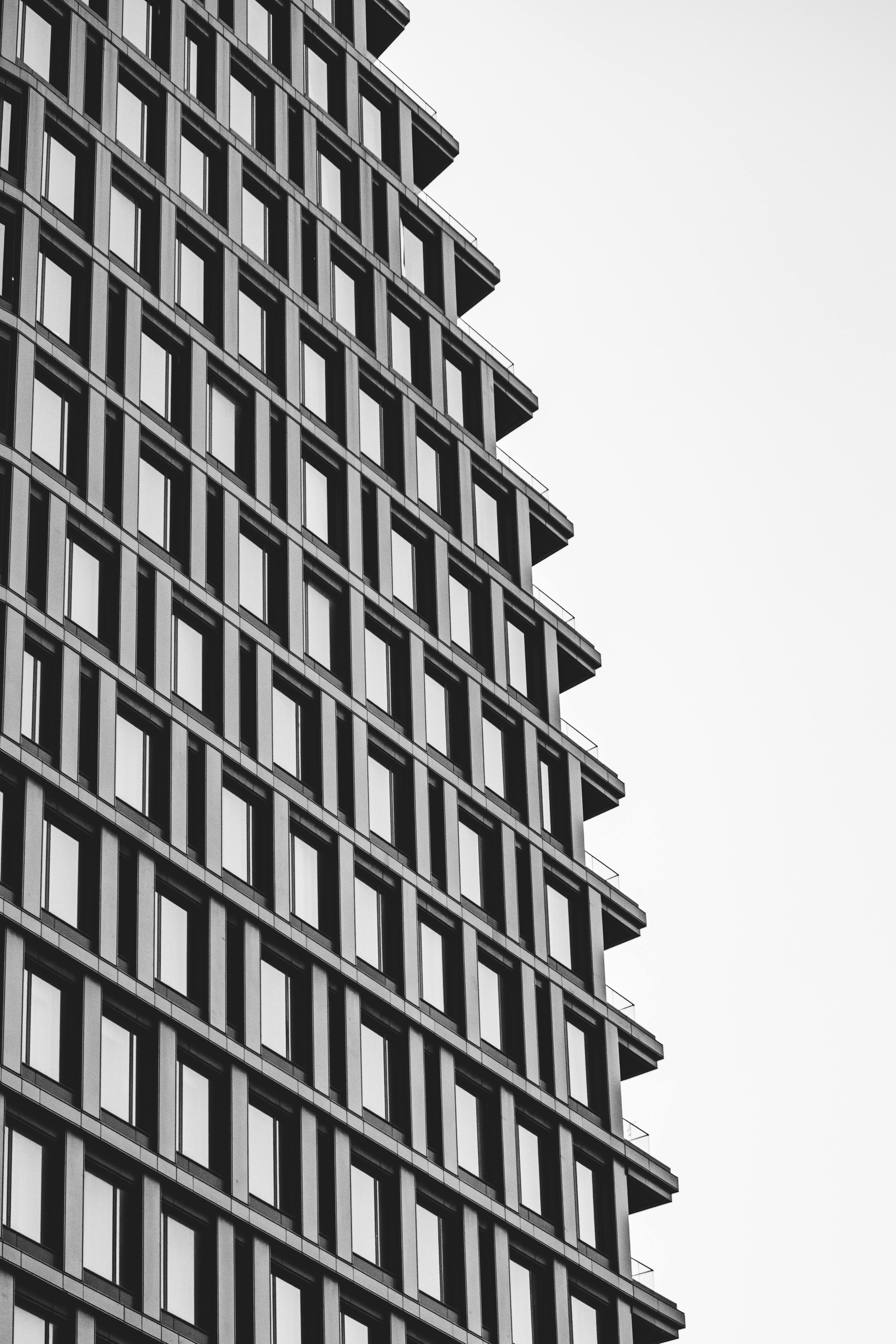 Black and white photo of a modern building facade in New York City, showcasing its geometric windows.