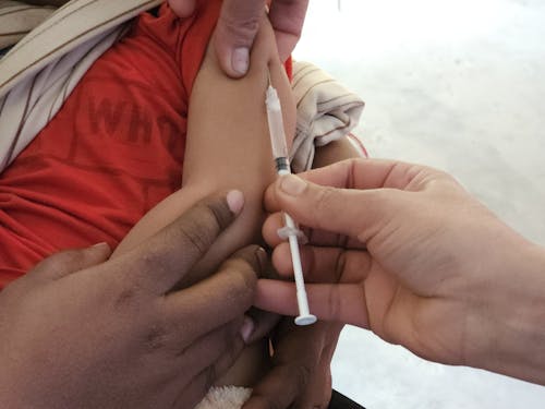 A person is giving a child a vaccine