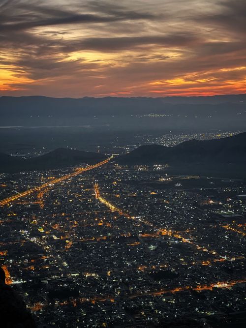 Free A stunning aerial view of Santiago, Chile, illuminated at sunset with a glowing sky. Stock Photo