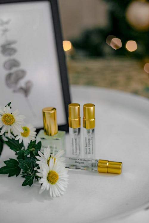 A picture of a white table with three bottles of perfume