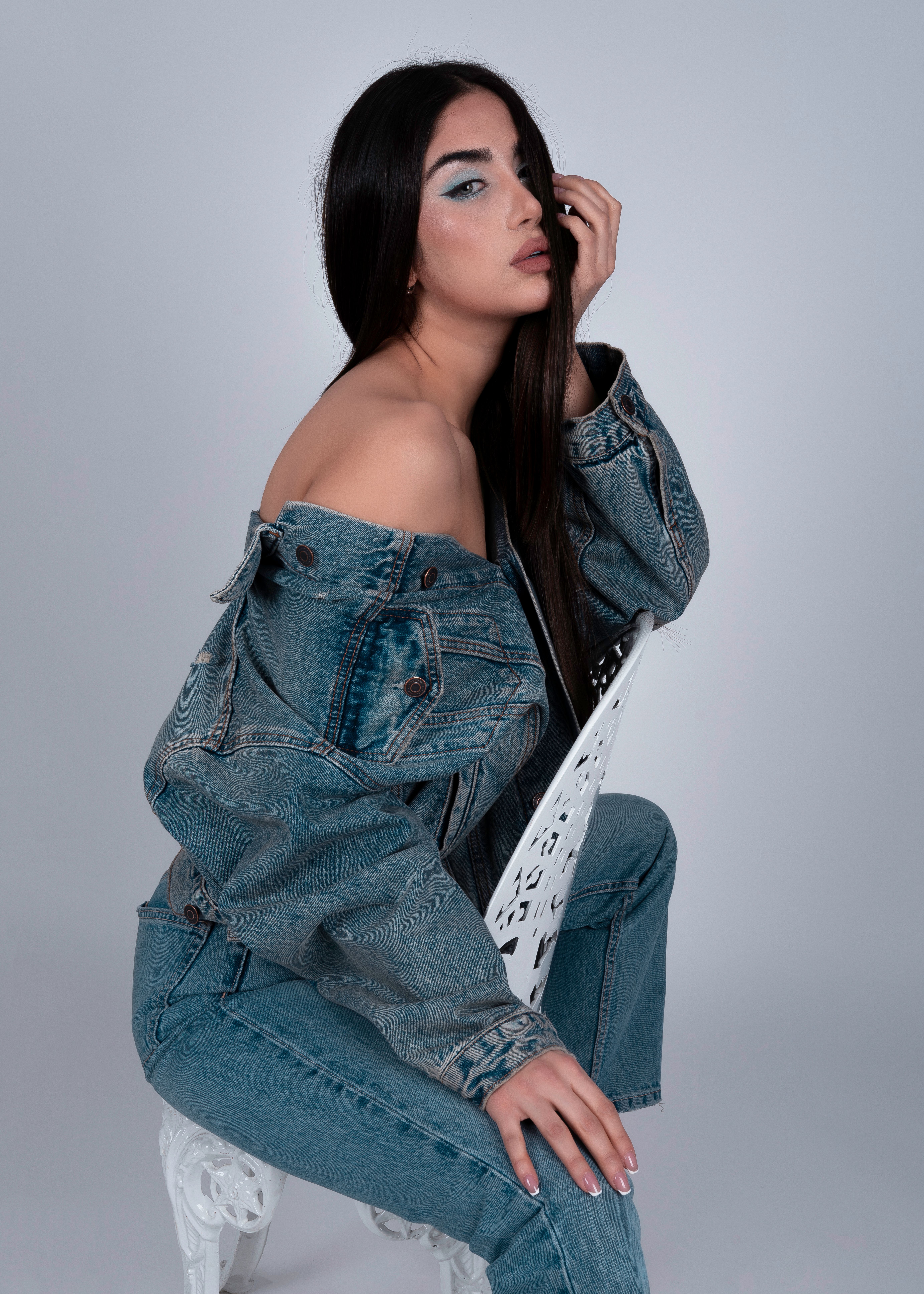 Brunette Woman in Denim Clothes Sitting on White Chair · Free Stock Photo