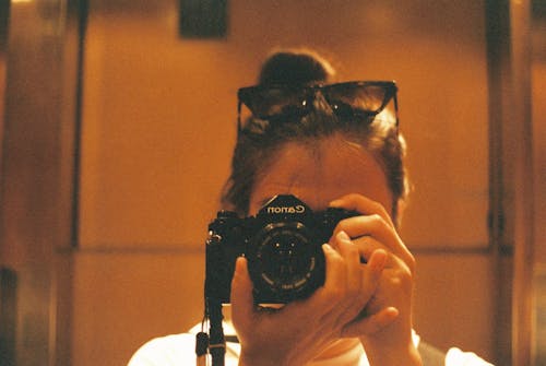 A woman taking a picture of herself with a camera