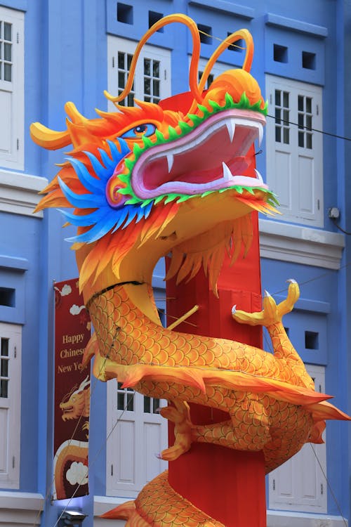 A large dragon statue is on display in front of a building