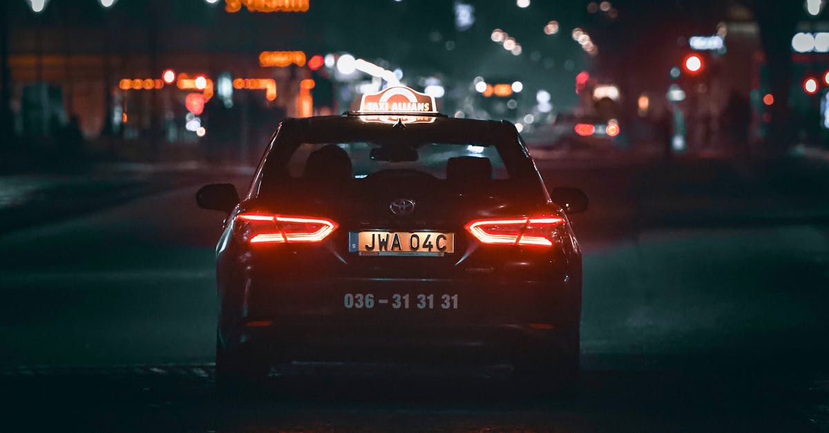 Photo by Efrem Efre A taxi drives through illuminated streets of Jönköping, Sweden at night, capturing the essence of city nightlife.