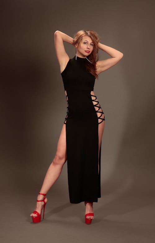 A woman in a black dress posing for a photo