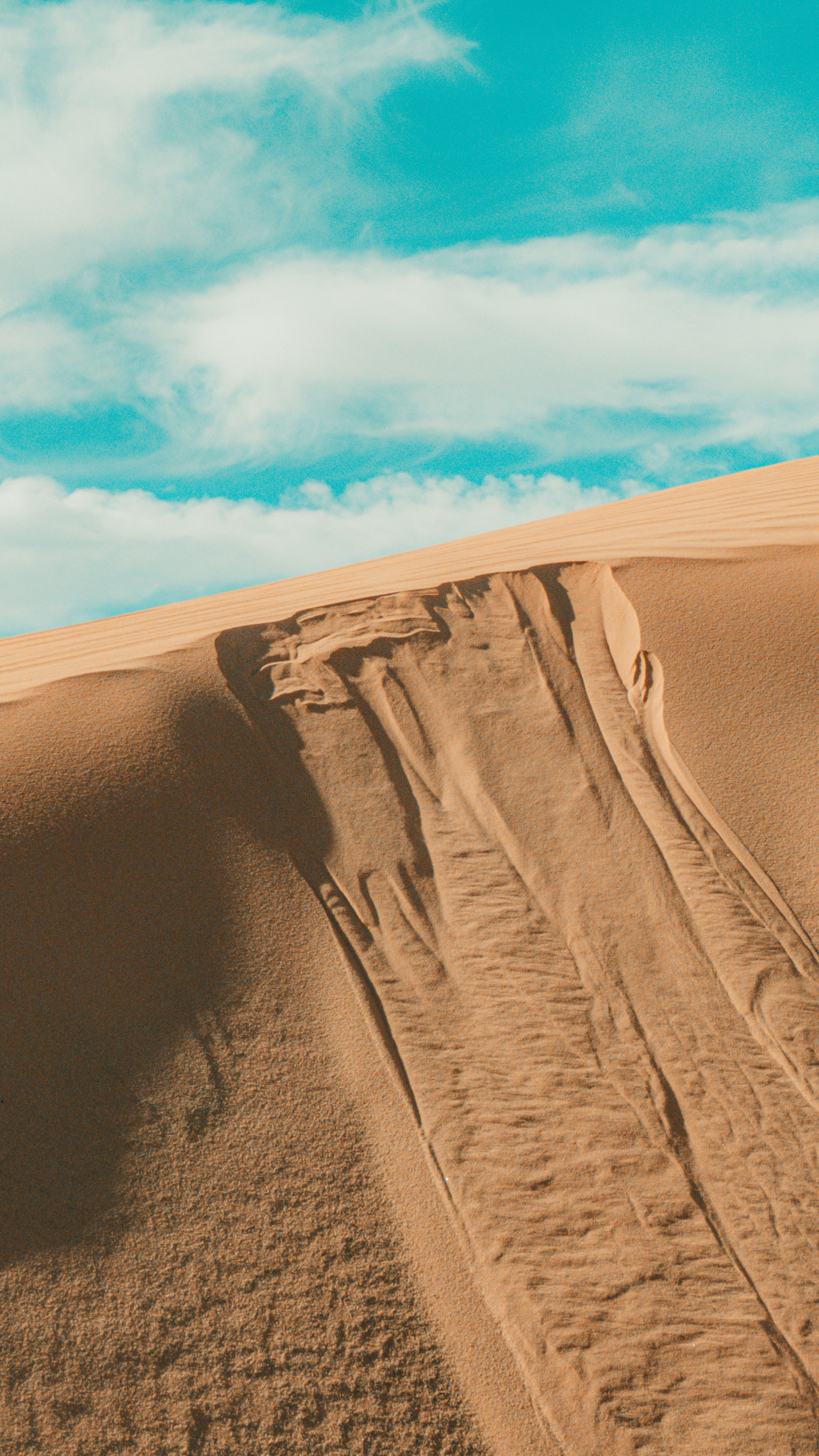View of a Sand Dune under Blue Sky with White Clouds · Free Stock Photo