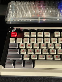 Detailed close-up of mechanical keyboards, highlighting keys with red accents in natural lighting.