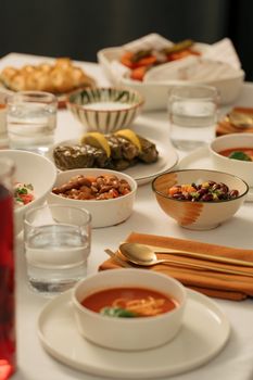 A beautifully arranged traditional Middle Eastern iftar meal with various dishes and drinks on a table.