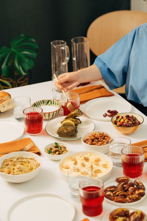Free A vibrant Turkish dining table setting featuring stuffed eggplant and various traditional dishes. Stock Photo