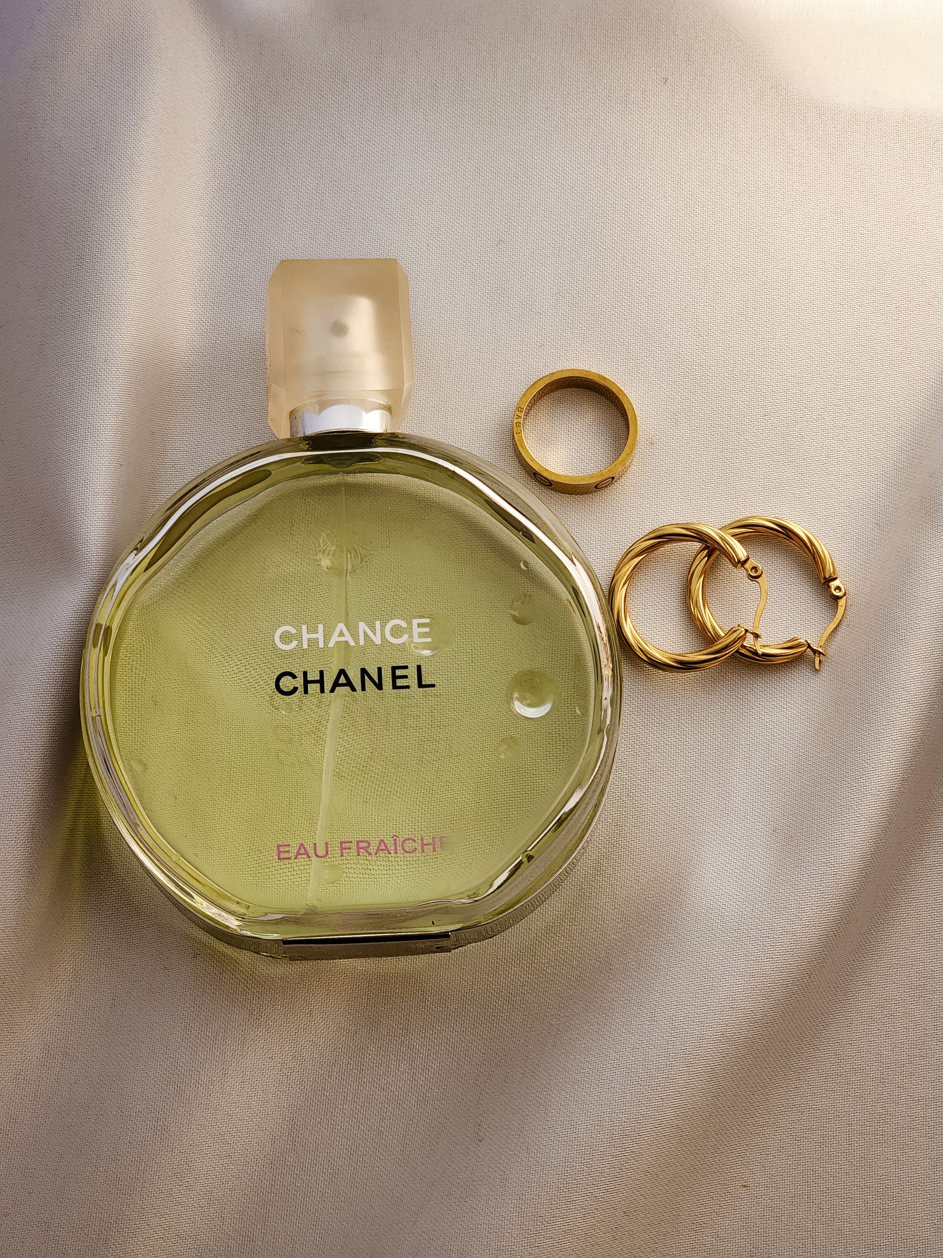 Elegant Chanel perfume bottle with gold accessories - Photo by Lala Jafarova on Pexels