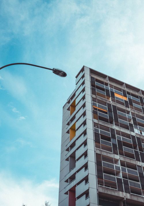 Free Urban architecture of a high-rise building in Bern with a blue sky backdrop. Stock Photo