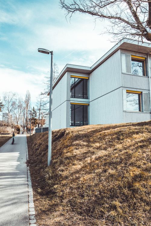 Free A stylish cubic house along a sidewalk in Berne, Switzerland on a clear day. Stock Photo