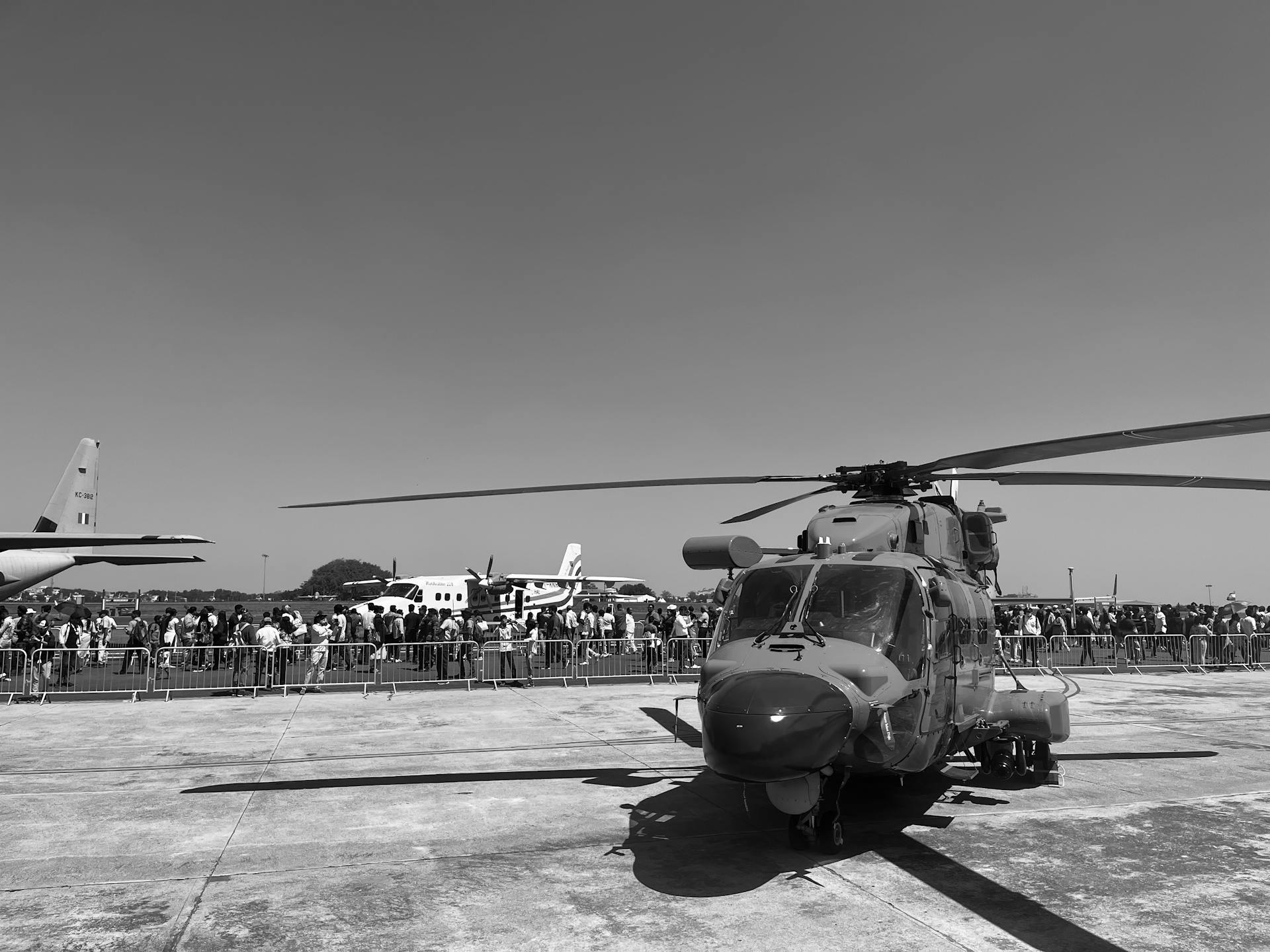 A helicopter showcased at an airshow in Bengaluru, highlighting military aviation on a sunny day.