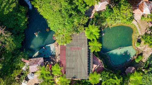 Aerial View of a Resort with a Swimming Pool and a Waterfall