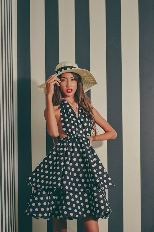 A woman in a polka dot dress and hat