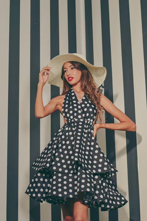 A woman in a polka dot dress and hat