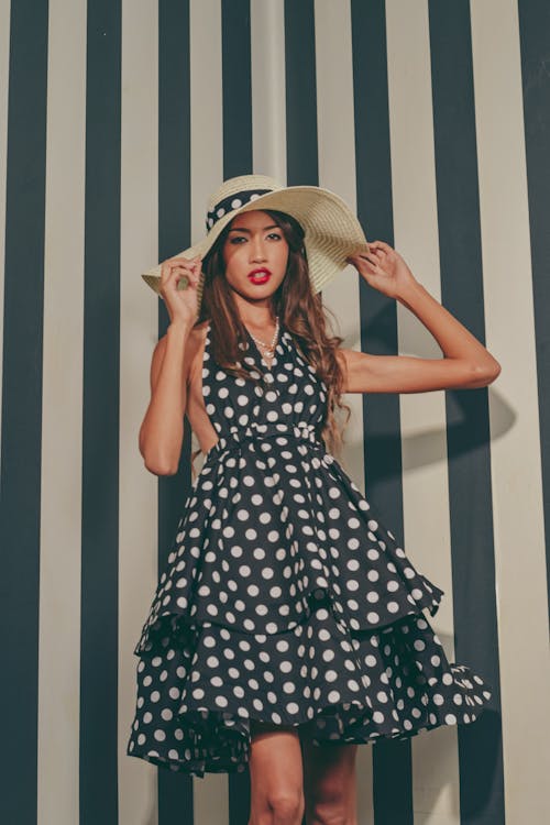 A woman in a polka dot dress and hat