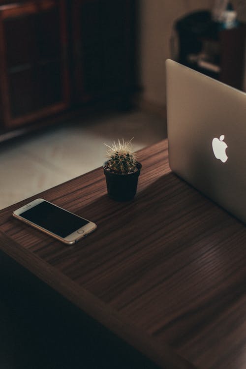 Free Iphone and Macbook on Table Stock Photo