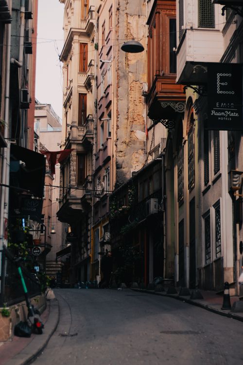 Free Explore this quaint urban alleyway featuring historic buildings and rich architectural details. Stock Photo