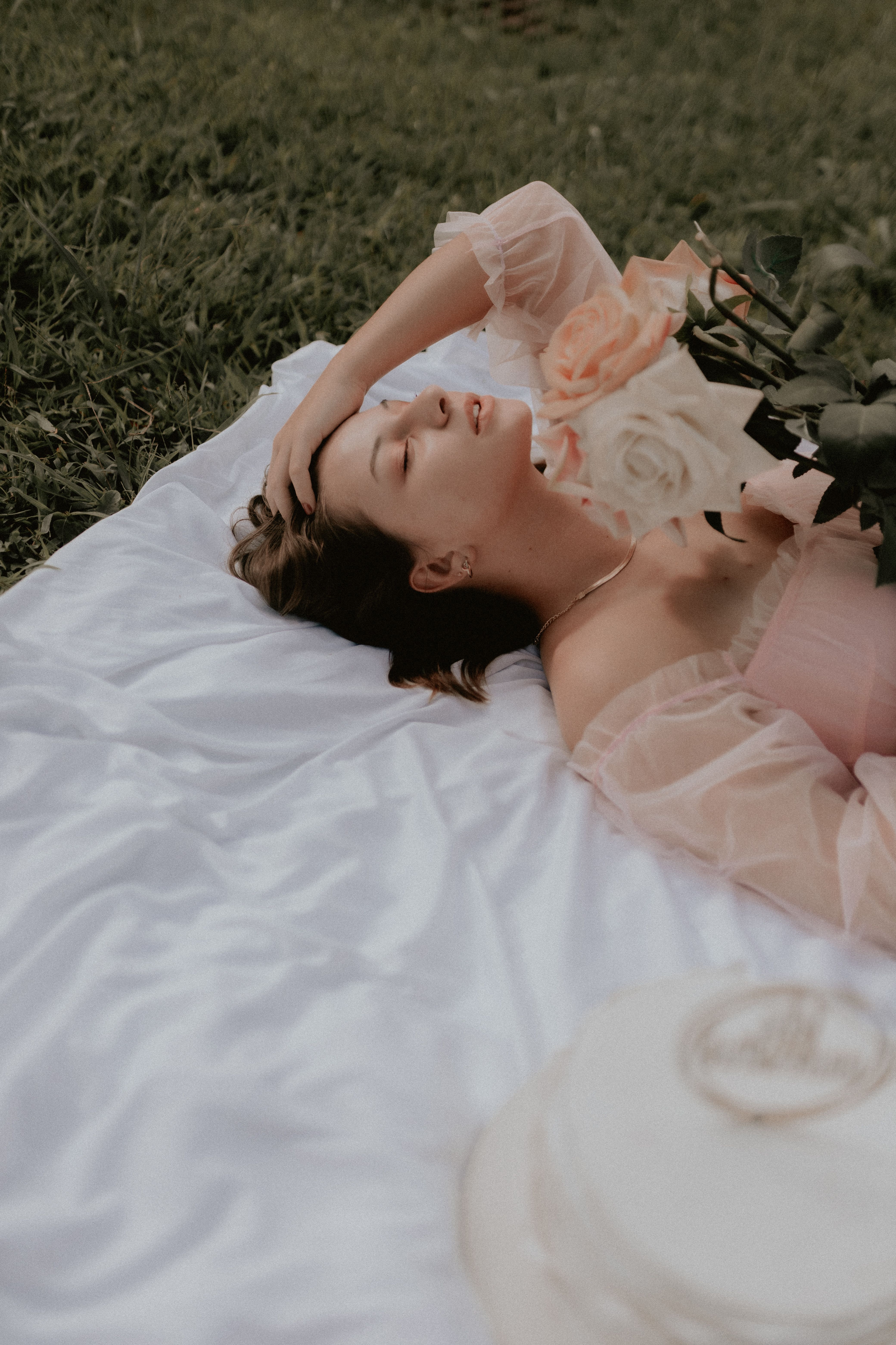 A Woman Lying on the Ground with her Eyes Closed · Free Stock Photo