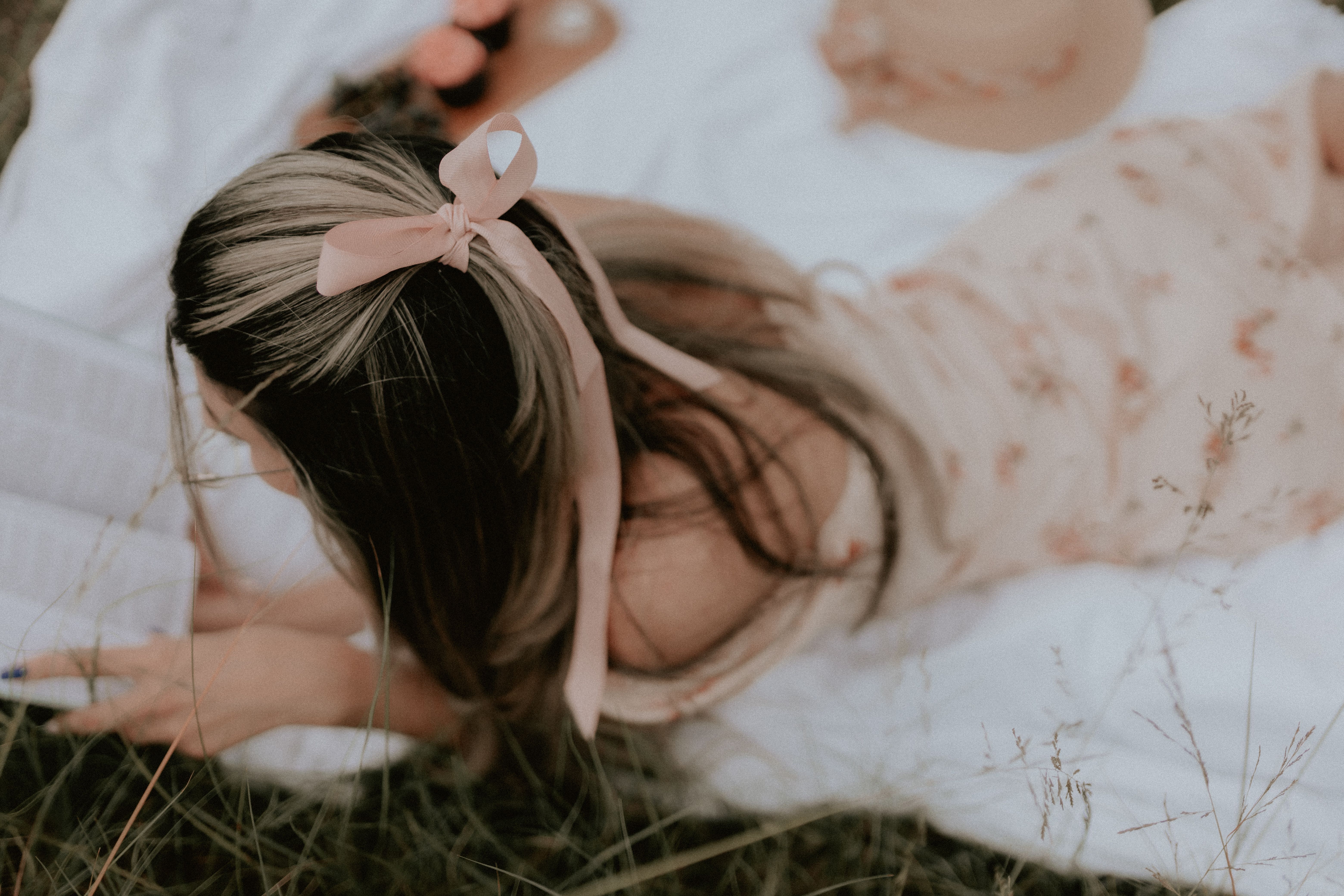 Young woman reading a book outdoors during a relaxing picnic on a warm day.