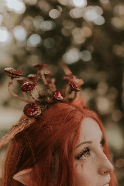 Woman with Ginger Hair Wearing a Headband with Antlers and Mushrooms