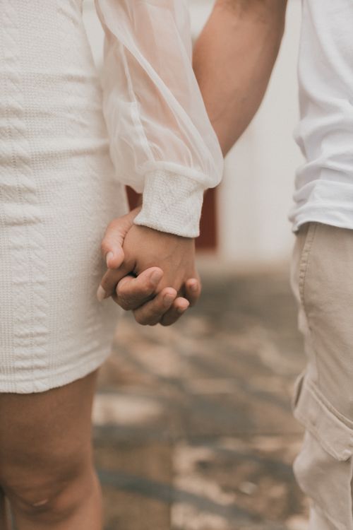 Free A close-up of a couple holding hands, symbolizing love and connection. Captured outdoors. Stock Photo